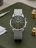 Men’s premium grey chronograph watch with silicone strap on green grass.